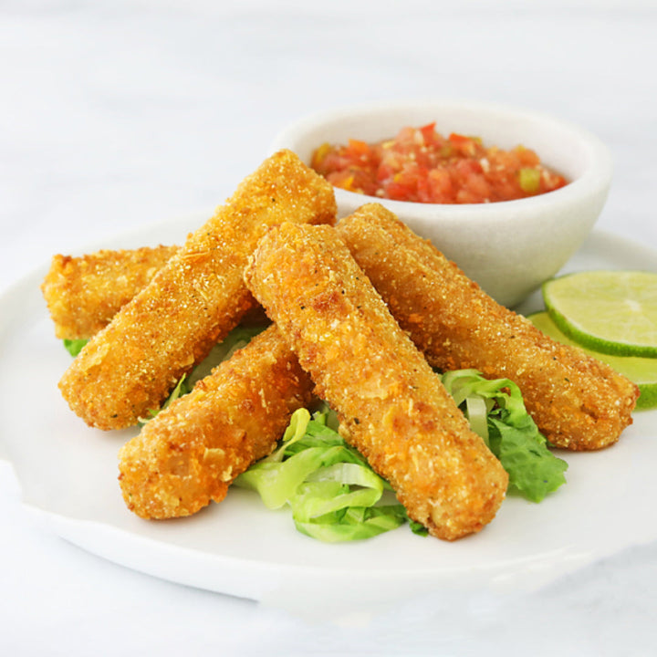 Fried cheese Chicken Fingers on a plate with a side of salsa and lime wedges.