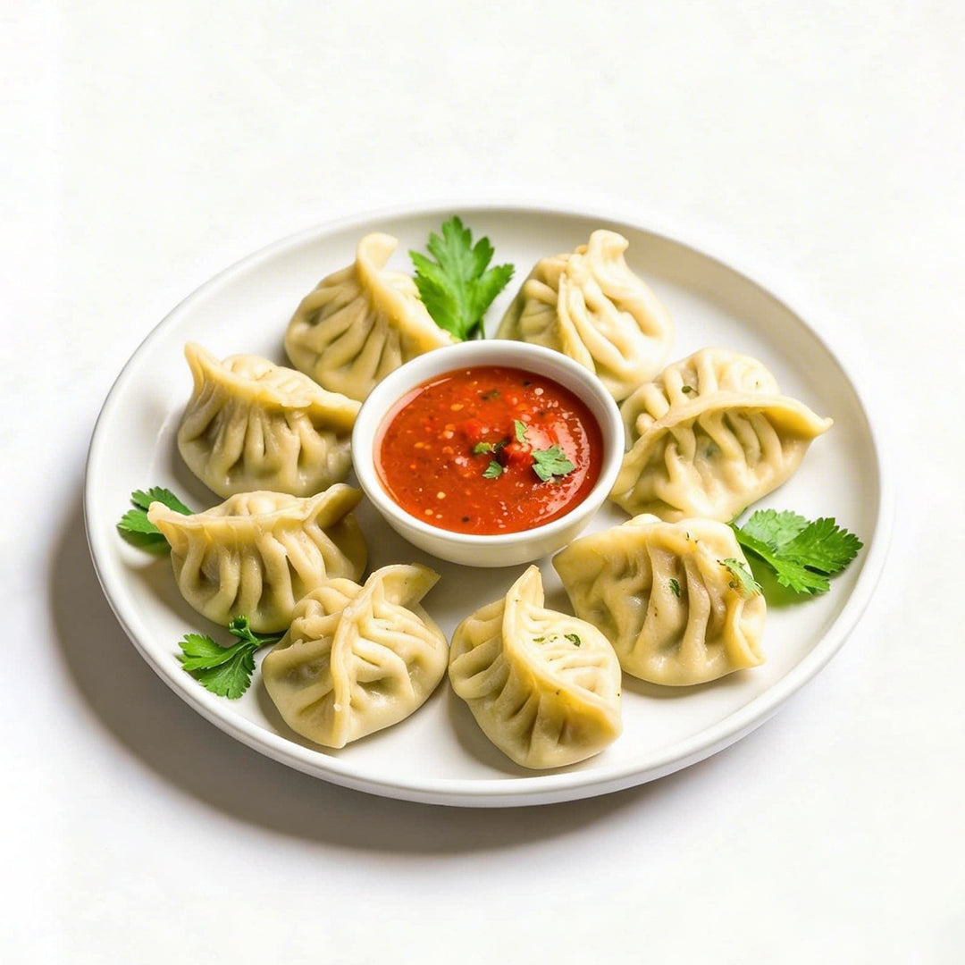 Chicken Momos in plate with red chutney 